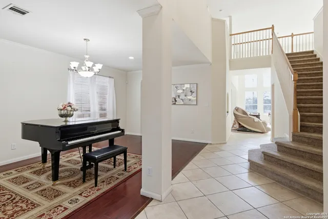 a living room with furniture and a chandelier