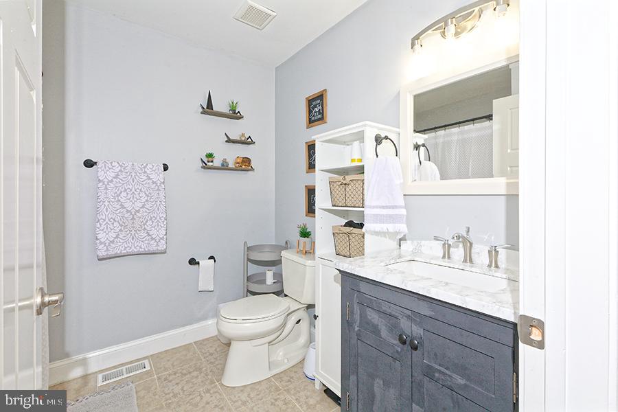 1044 Center Street Tuckerton, NJ 08087 - Photo 22 of 27 a bathroom with a granite countertop toilet sink and a mirror