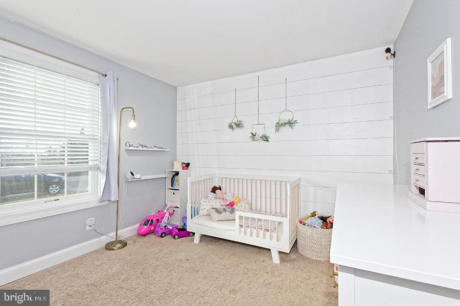 1044 Center Street Tuckerton, NJ 08087 - Photo 23 of 27 a bed room with a bed and potted plant