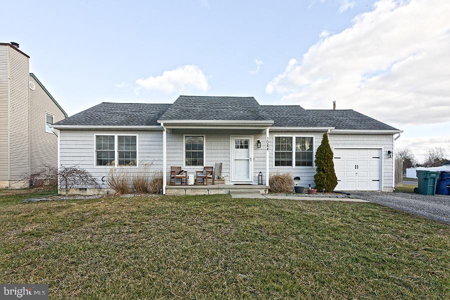 1044 Center Street Tuckerton, NJ 08087 - Photo 3 of 27 a front view of house with yard and chairs in patio