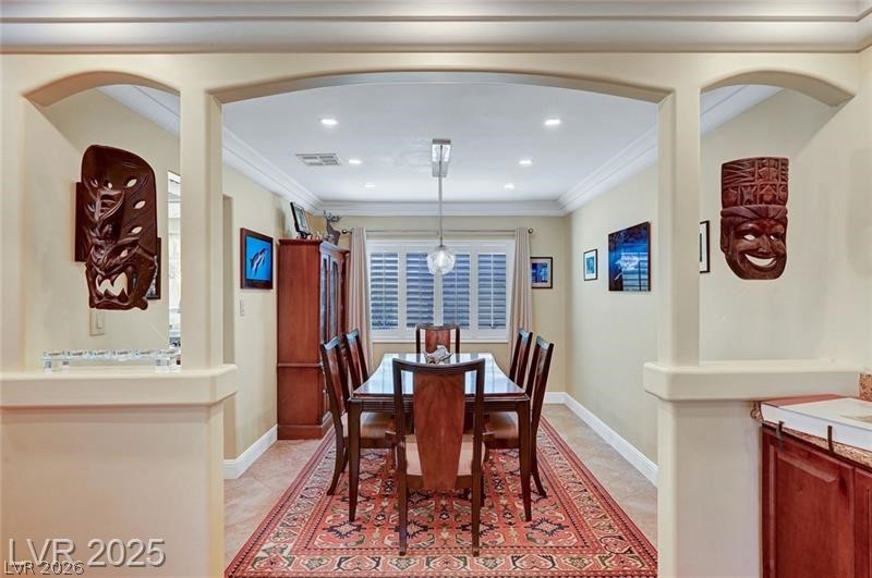 2410 Doherty Way Henderson, NV 89014 - Photo 16 of 63 Dining space featuring arched walkways, baseboards, crown molding, recessed lighting, and light tile patterned floors