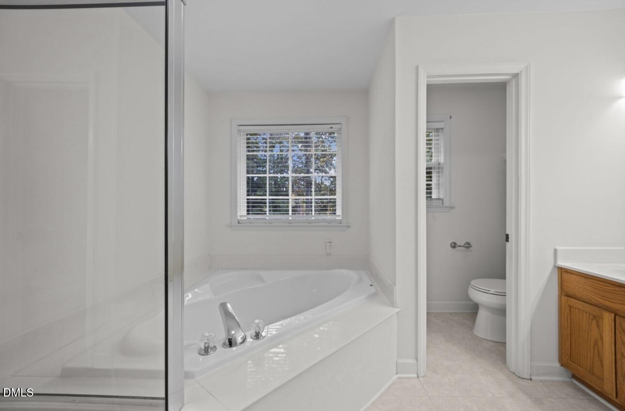 3616 Dewing Drive Raleigh, NC 27616 - Photo 14 of 25 a bath room with a bath tub and a toilet