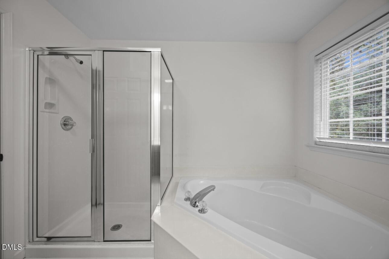 3616 Dewing Drive Raleigh, NC 27616 - Photo 15 of 25 a bathroom with a bathtub and a shower