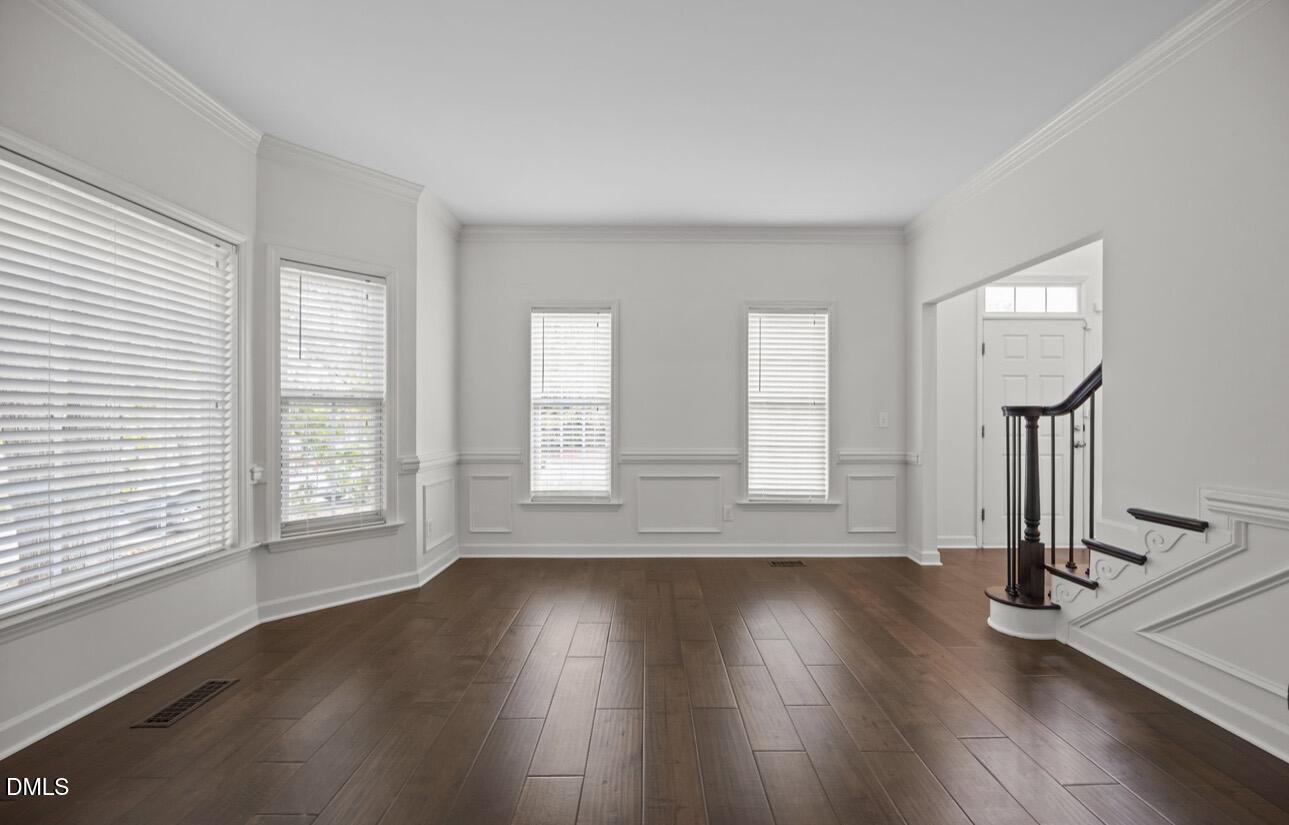 3616 Dewing Drive Raleigh, NC 27616 - Photo 4 of 25 a view of an empty room with wooden floor and a window