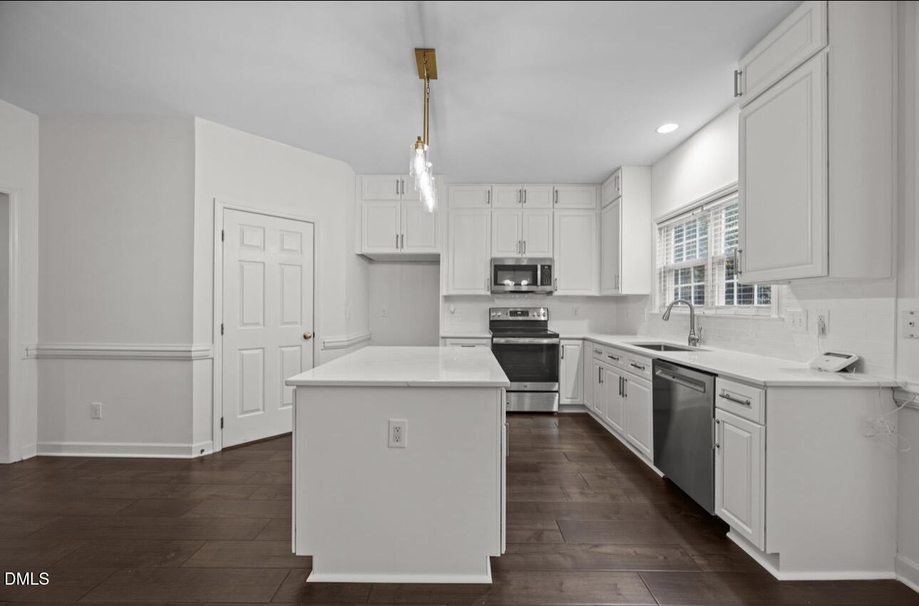 3616 Dewing Drive Raleigh, NC 27616 - Photo 6 of 25 a kitchen with stainless steel appliances granite countertop a sink stove and refrigerator