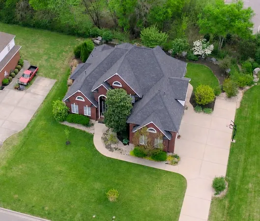 an aerial view of a house with garden space and street view
