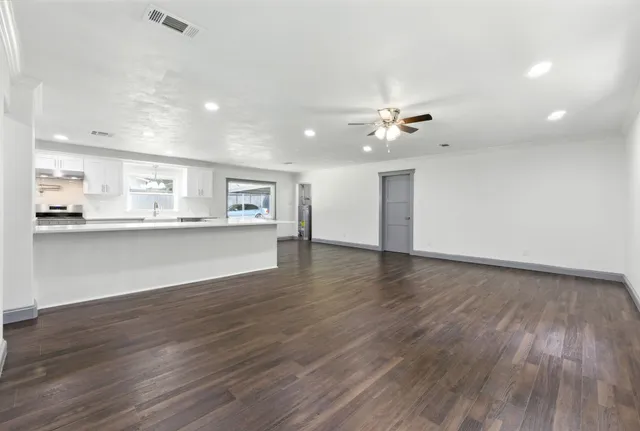 a view of kitchen and hall with wooden floor