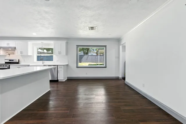 a view of kitchen with wooden floor and windows