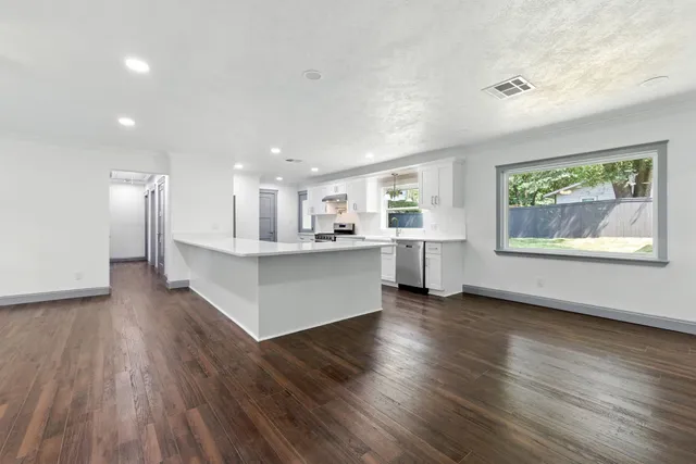 a view of kitchen with cabinets and wooden floor