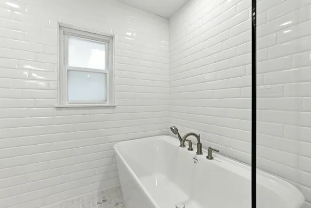 a bathroom with a shower and a sink