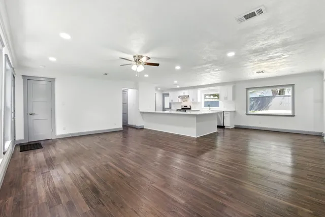 a kitchen with a stove and white cabinets