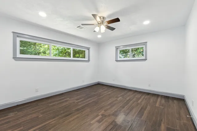a view of an empty room with wooden floor