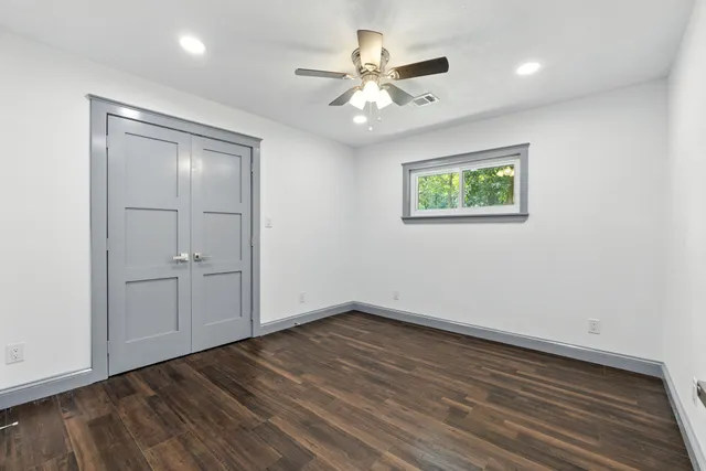 a front view of house with yard and trees in the background