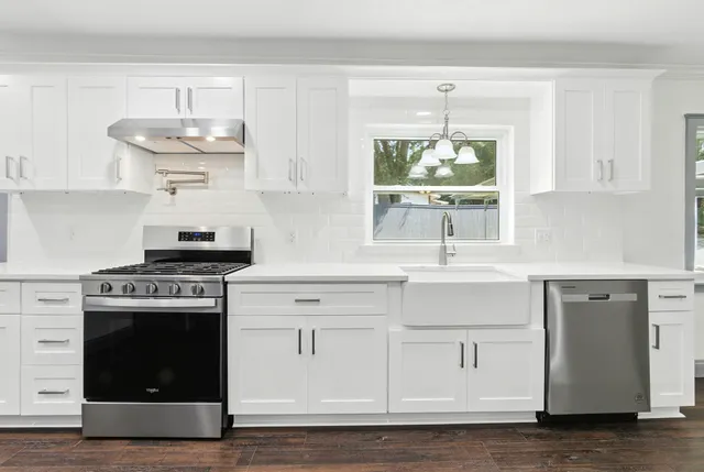 a view of kitchen with cabinets and wooden floor