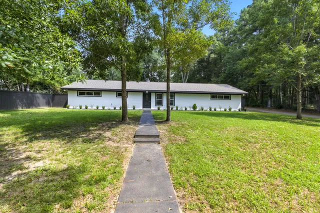 a front view of a house with garden and porch