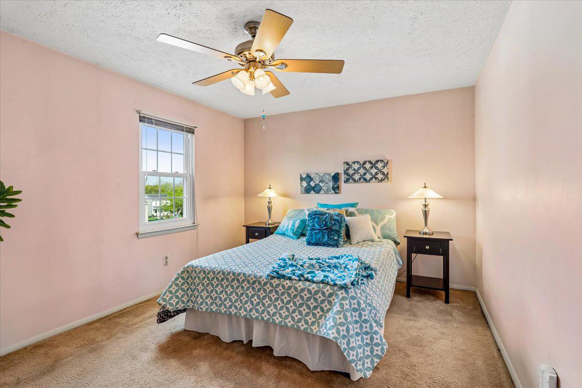 5614 Cliff Side Court Baltimore, MD 21225 - Photo 11 of 28 a bedroom with a bed and a chandelier