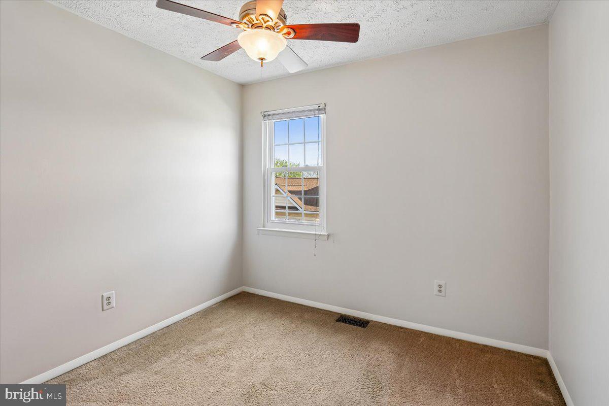 5614 Cliff Side Court Baltimore, MD 21225 - Photo 13 of 28 an empty room with a window and a fan