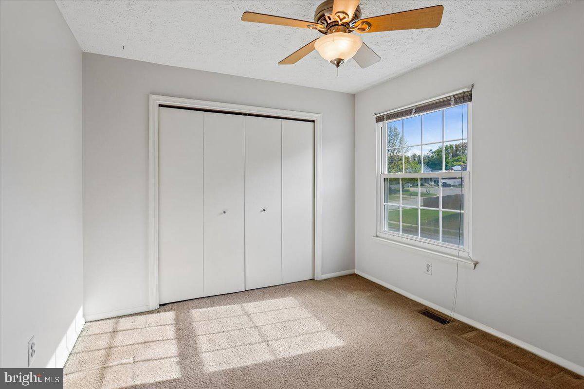 5614 Cliff Side Court Baltimore, MD 21225 - Photo 16 of 28 an empty room with windows and fan
