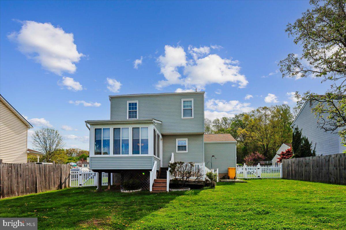 5614 Cliff Side Court Baltimore, MD 21225 - Photo 18 of 28 a view of a house with a yard and a patio