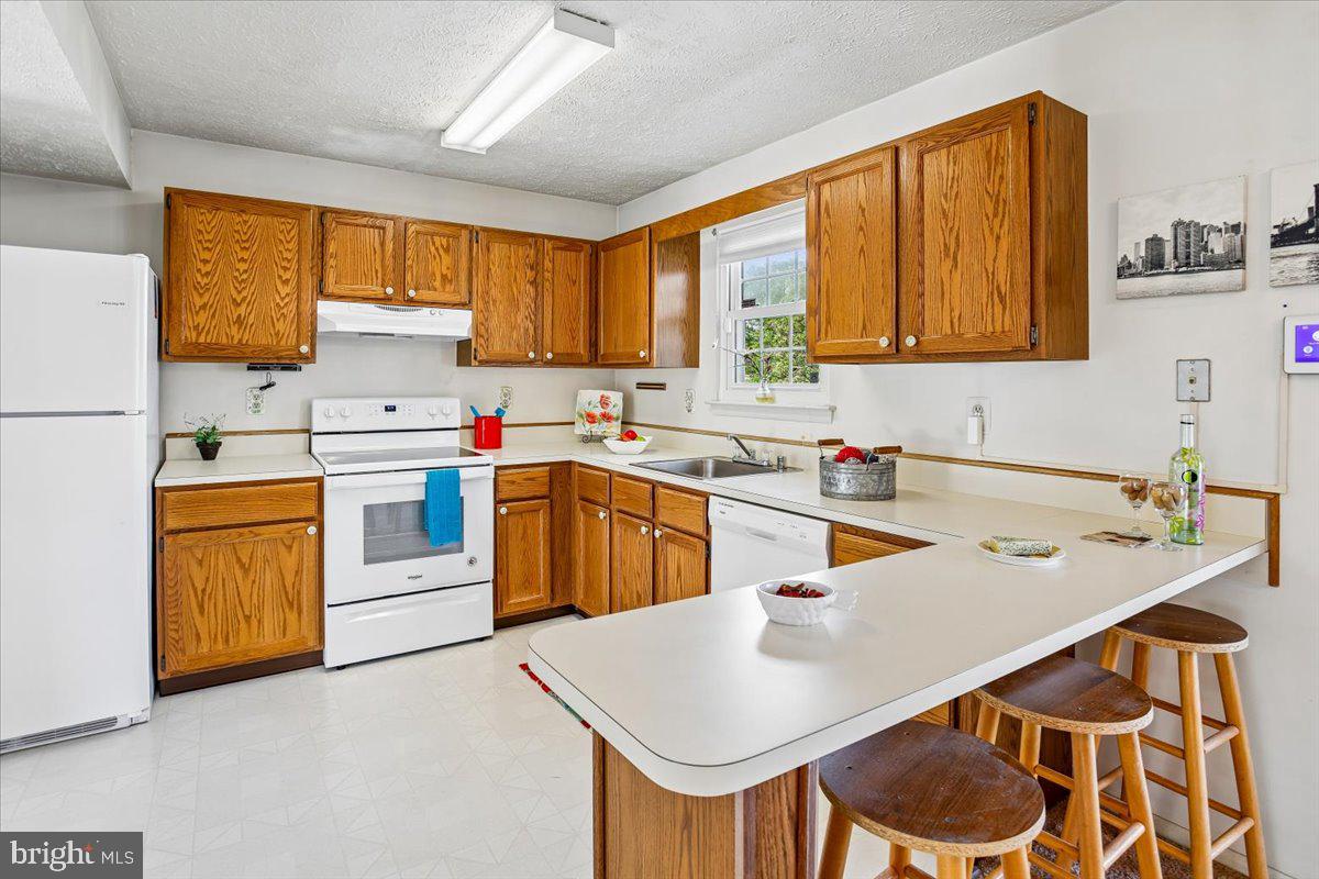 5614 Cliff Side Court Baltimore, MD 21225 - Photo 5 of 28 a kitchen with a sink appliances and cabinets