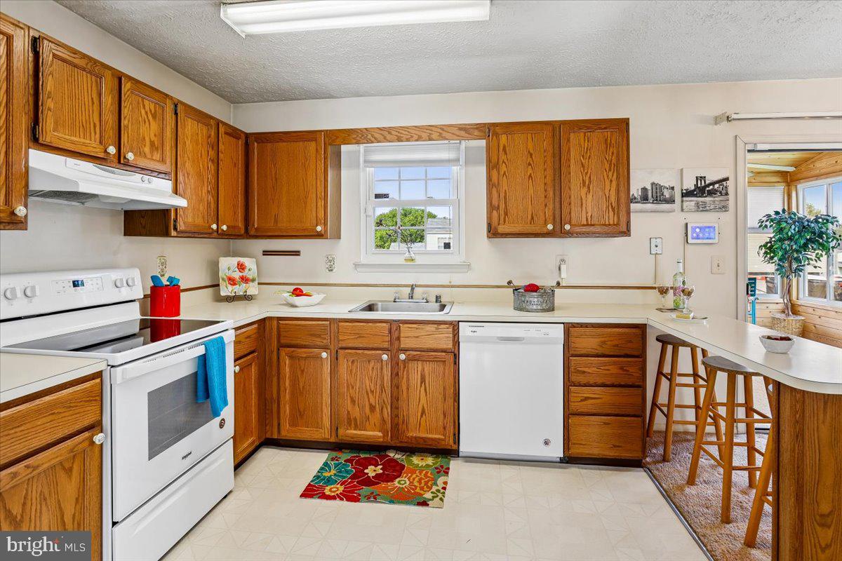 5614 Cliff Side Court Baltimore, MD 21225 - Photo 6 of 28 a kitchen with stainless steel appliances sink cabinets and window