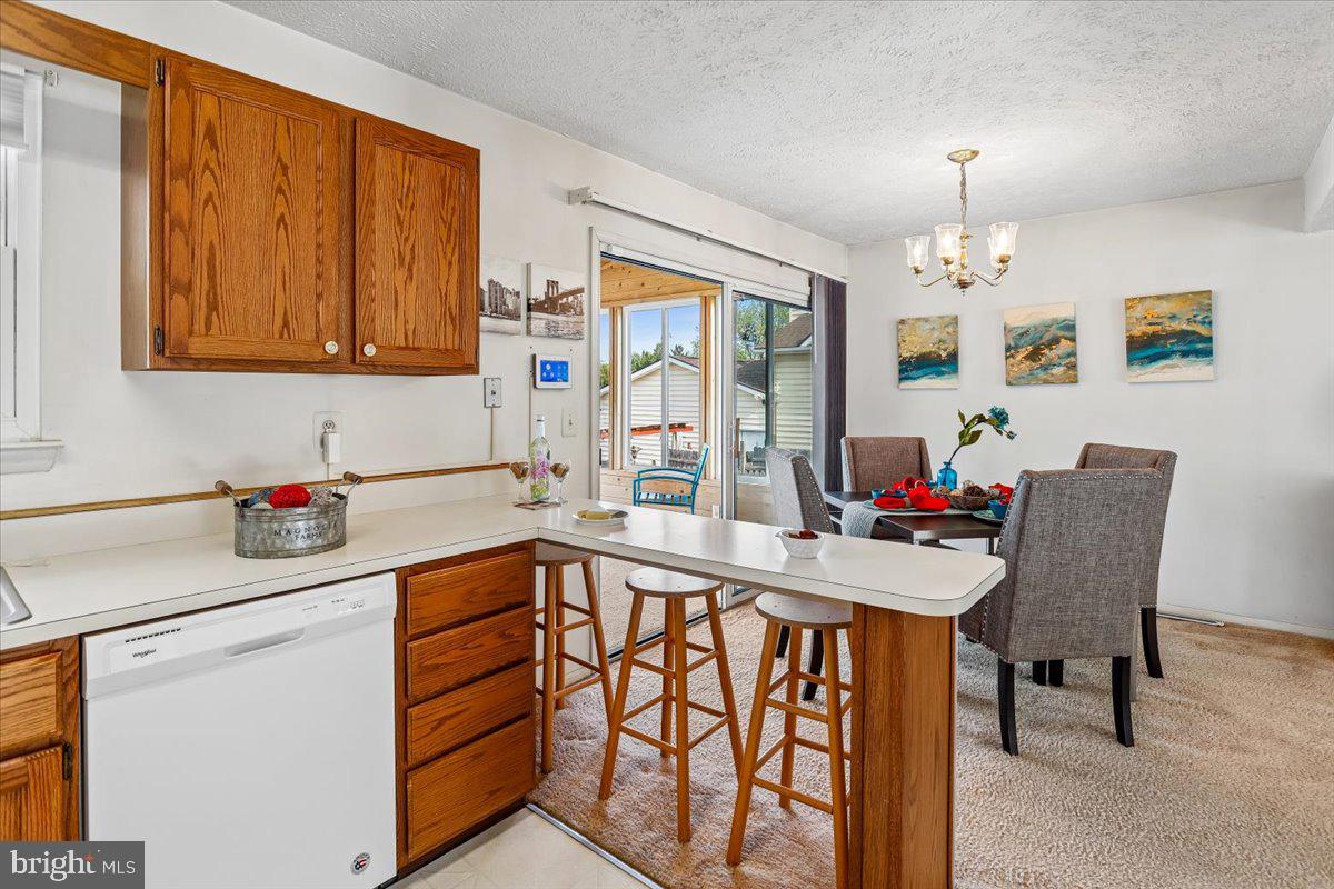 5614 Cliff Side Court Baltimore, MD 21225 - Photo 7 of 28 a kitchen that has a cabinets counter space dining table and a sink