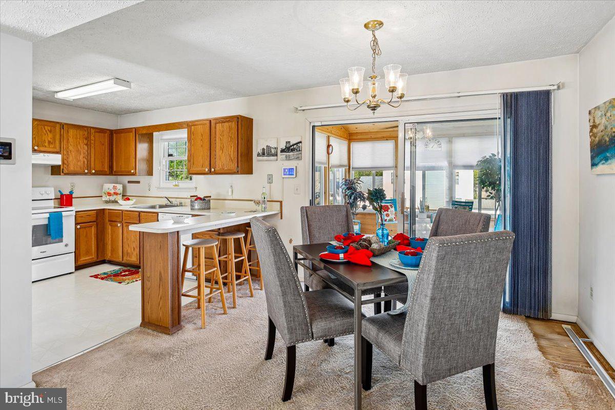 5614 Cliff Side Court Baltimore, MD 21225 - Photo 8 of 28 a view of a dining room with furniture and chandelier
