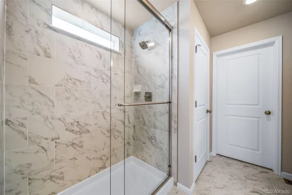 a bathroom with a bathtub and shower