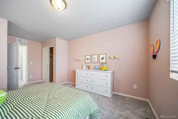 a bedroom with a bed and cabinets