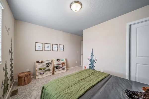 a bedroom with furniture and a wooden floor