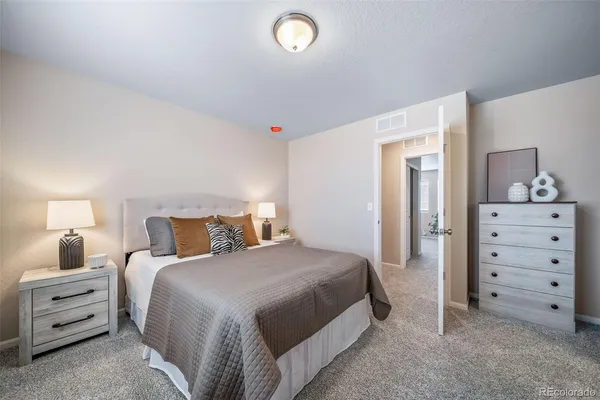 a bedroom with a bed and a dresser