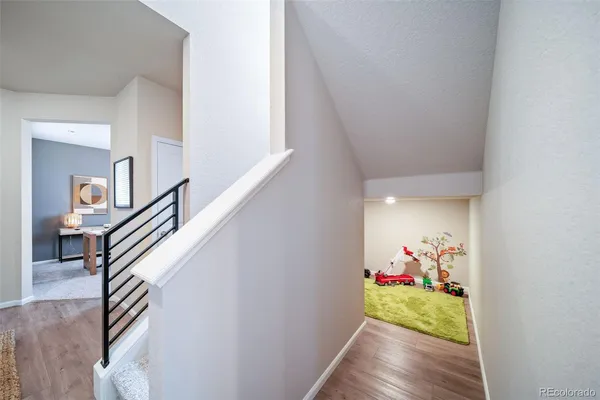 a view of a dining room with wooden floor and stairs