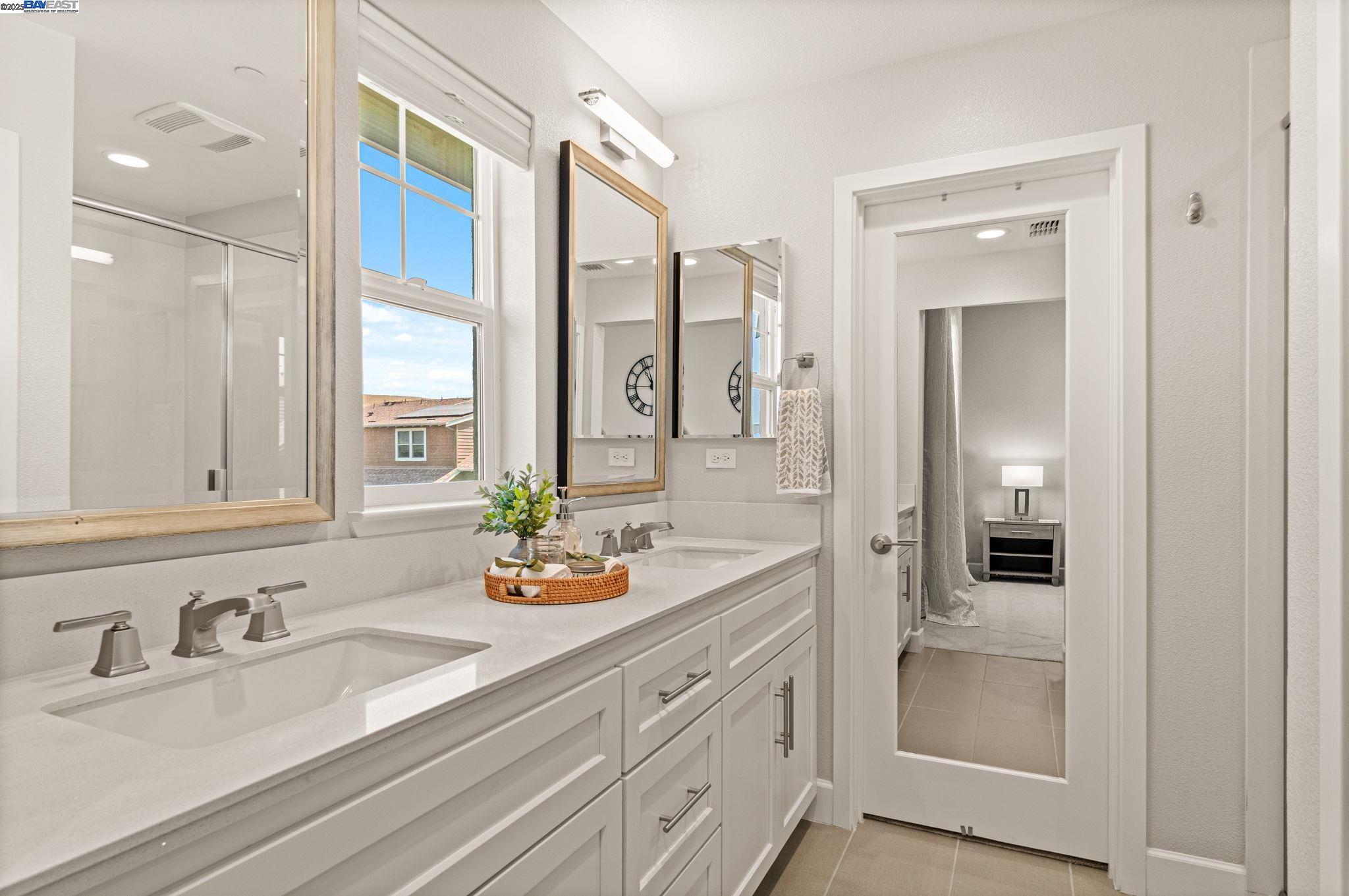 849 Tranquility Circle, Unit 3 Livermore, CA 94551 - Photo 18 of 60 a bathroom with double vanity sinks and a mirror