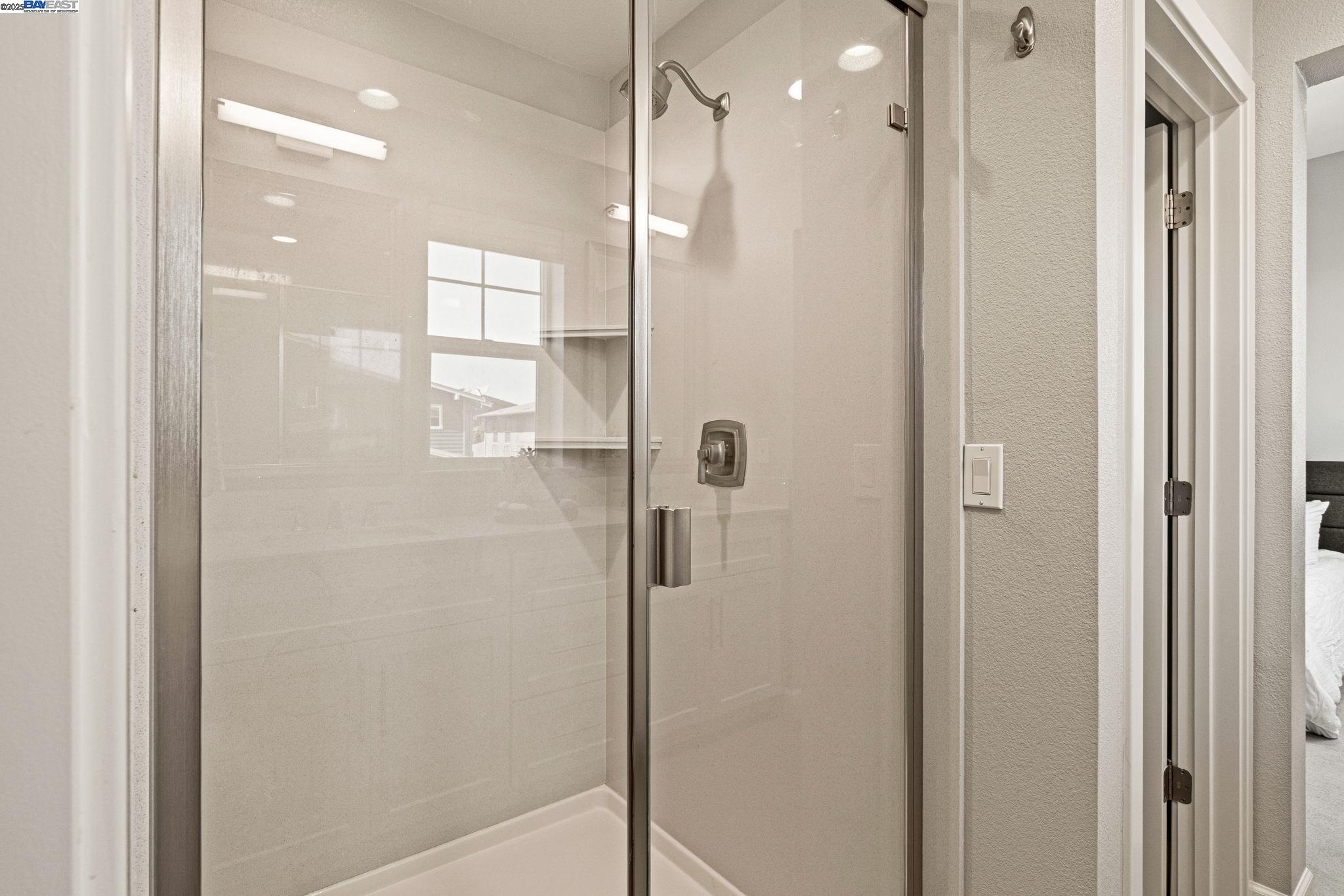 849 Tranquility Circle, Unit 3 Livermore, CA 94551 - Photo 19 of 60 a bathroom with a glass shower door