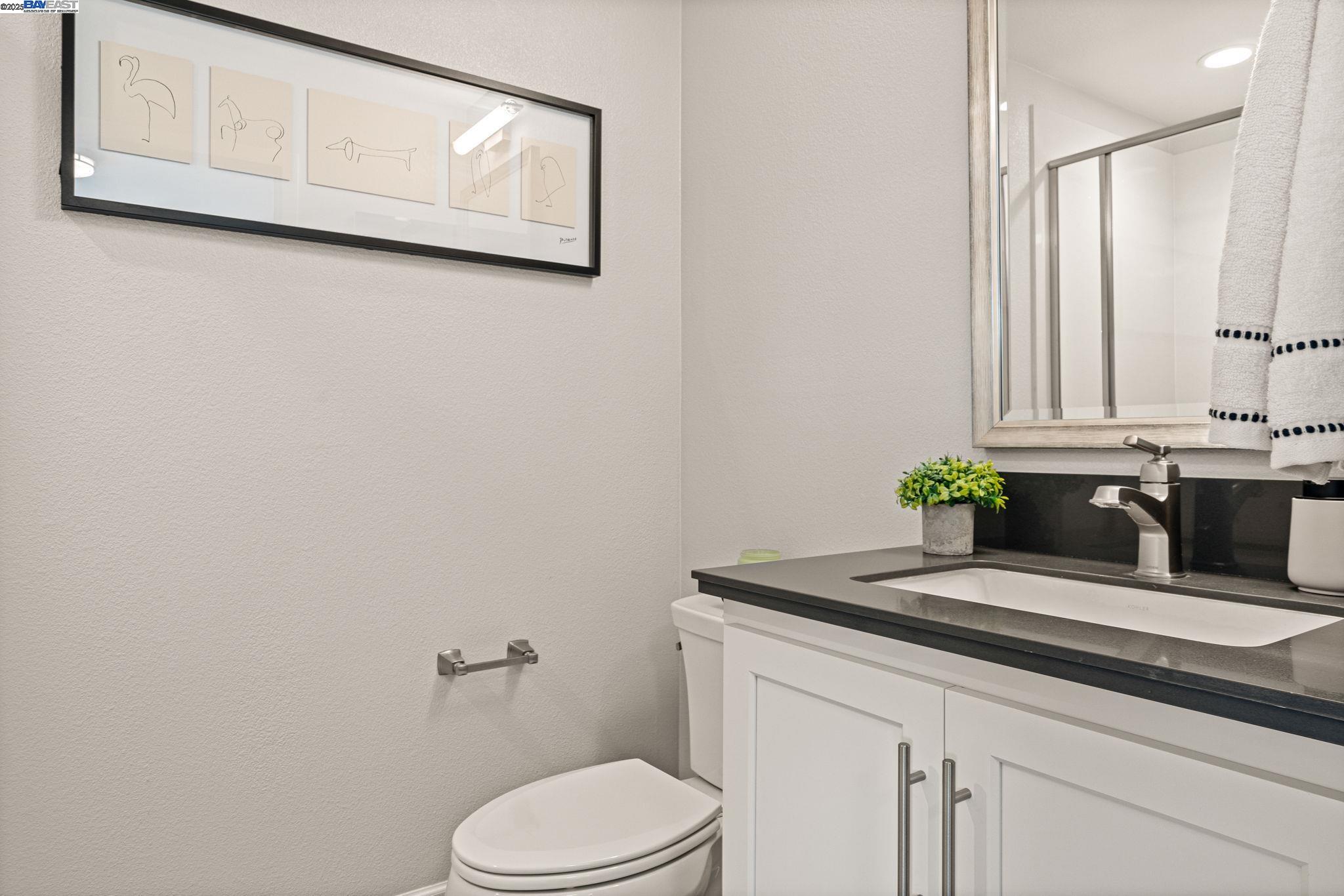 849 Tranquility Circle, Unit 3 Livermore, CA 94551 - Photo 25 of 60 a bathroom with a granite countertop sink and a toilet
