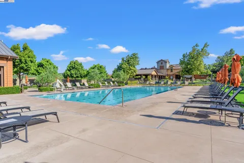 a kitchen with a sink a counter top space and stainless steel appliances