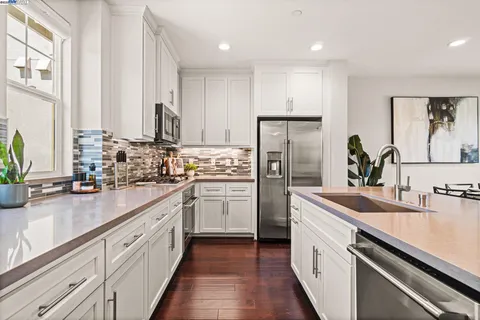 a kitchen with refrigerator and cabinets