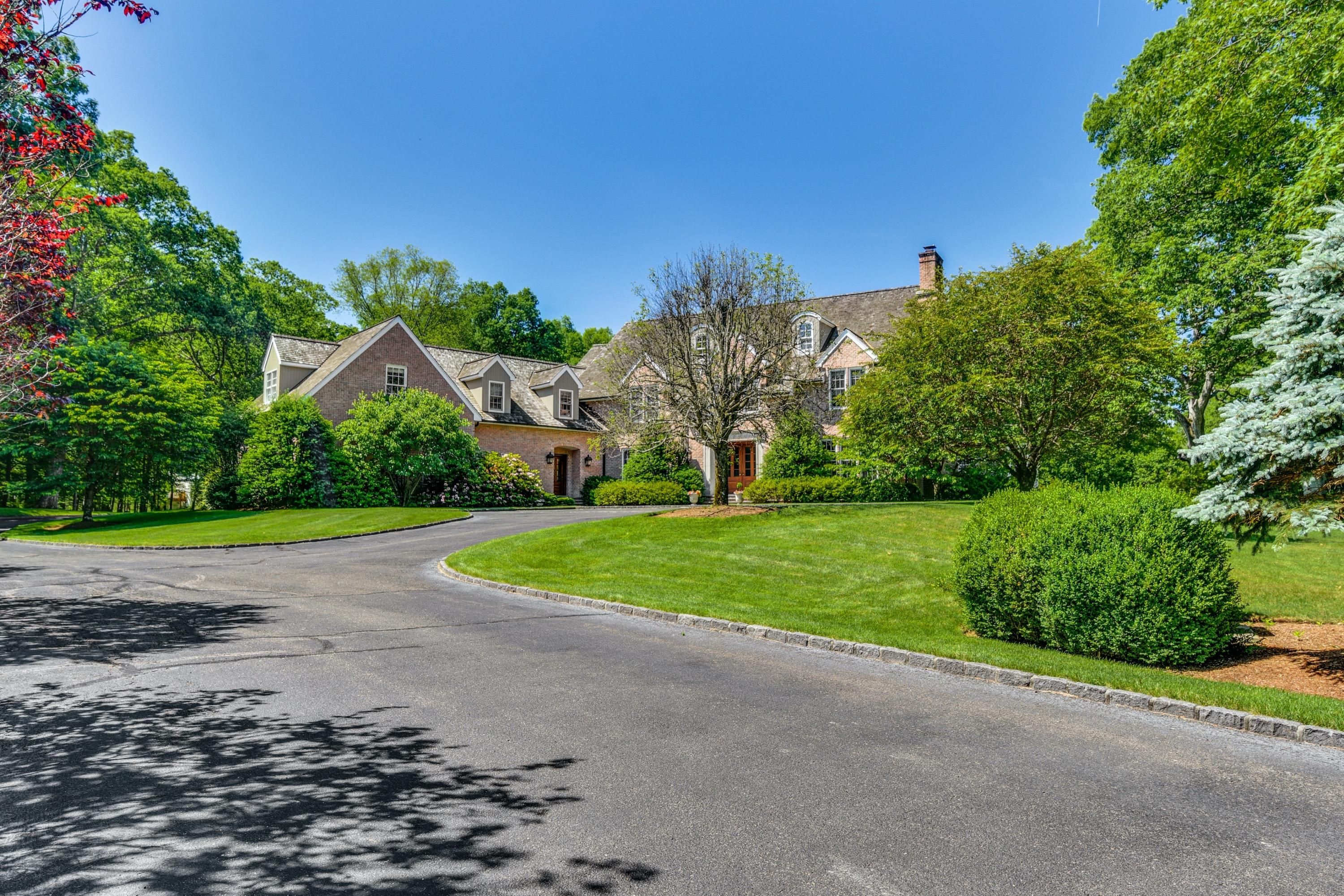 910 Smith Ridge Road New Canaan, CT 06840 - Photo 2 of 40 a view of a house with a big yard and palm trees