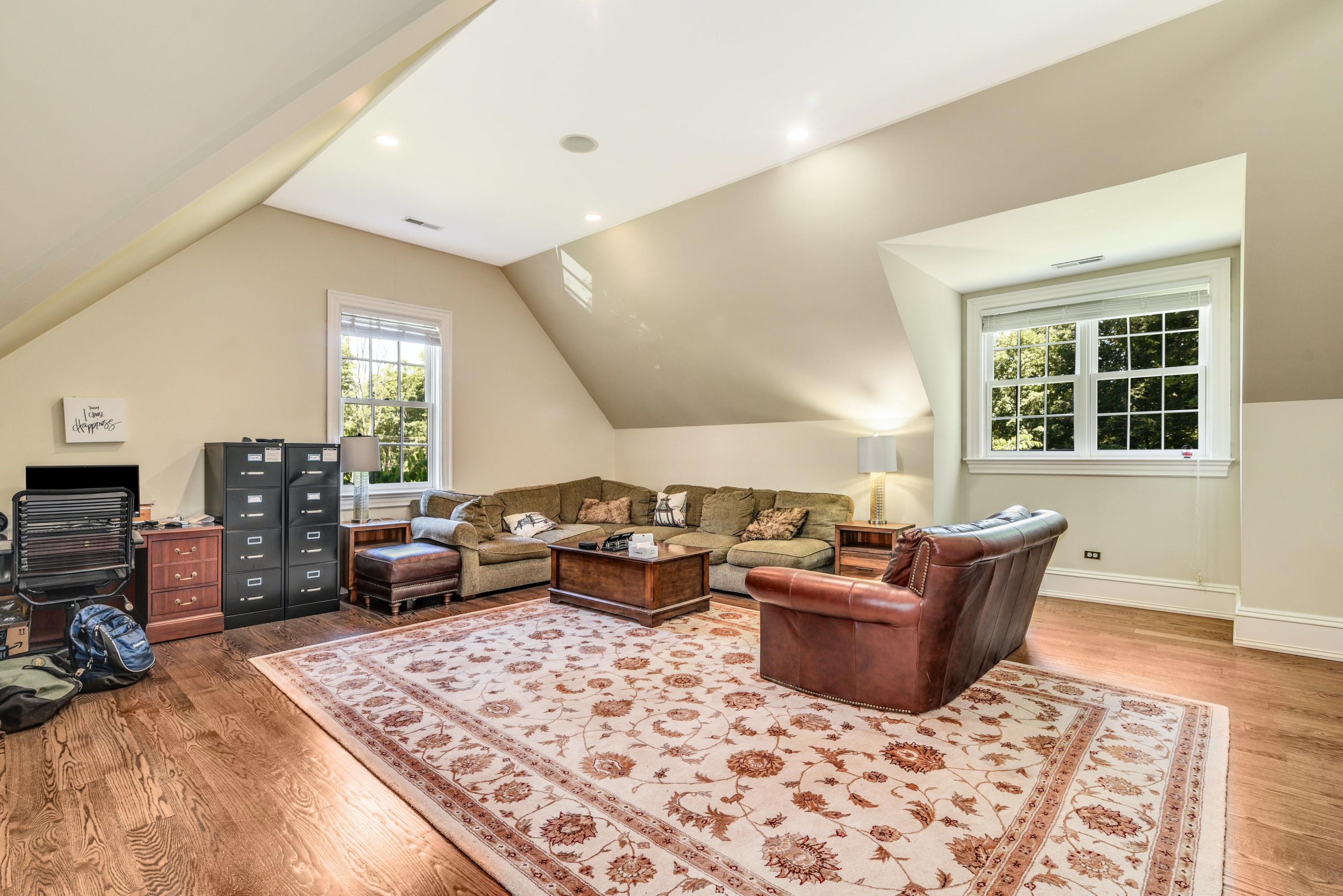 910 Smith Ridge Road New Canaan, CT 06840 - Photo 19 of 40 a living room with furniture a rug and a window