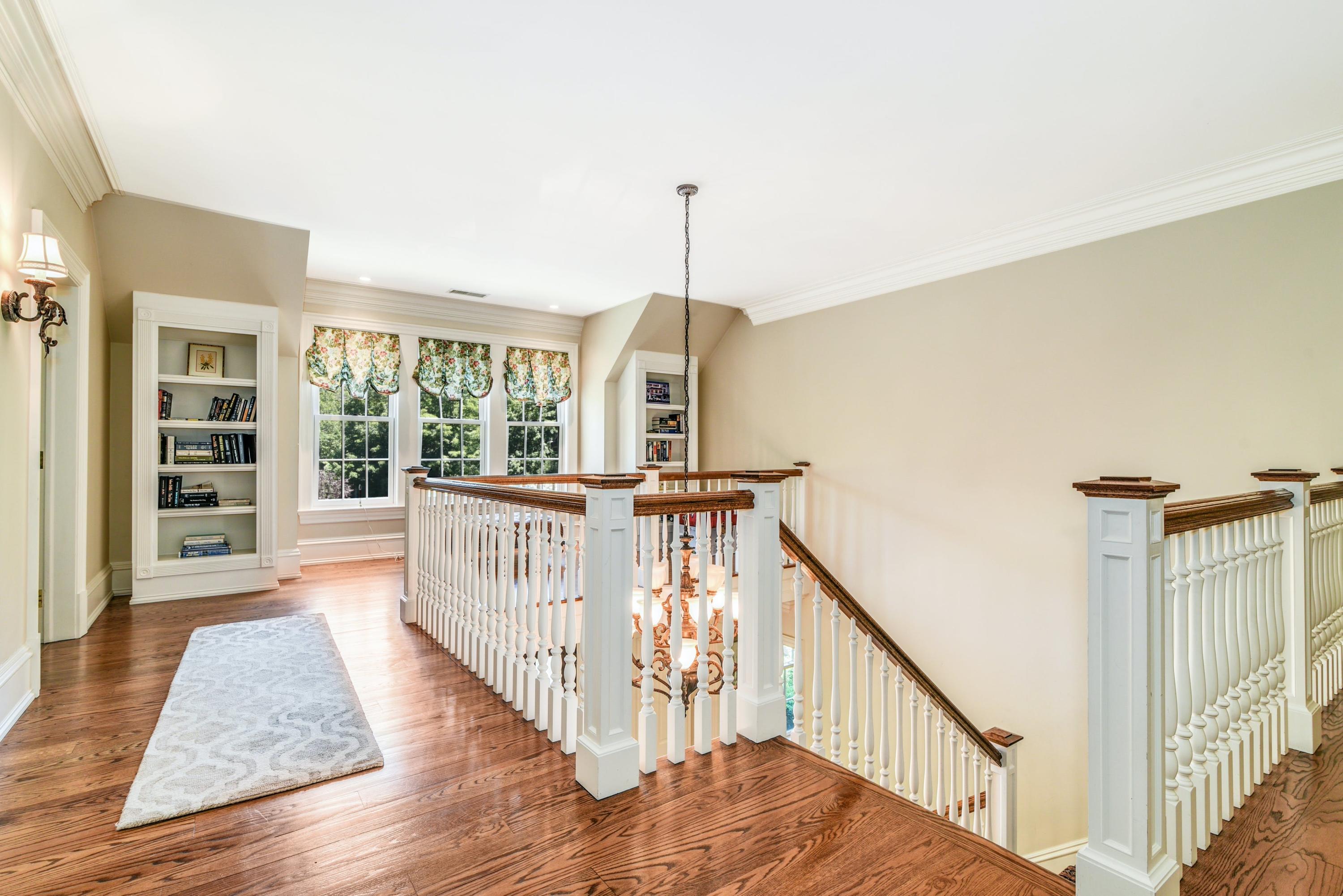 910 Smith Ridge Road New Canaan, CT 06840 - Photo 21 of 40 a view of a hallway with windows