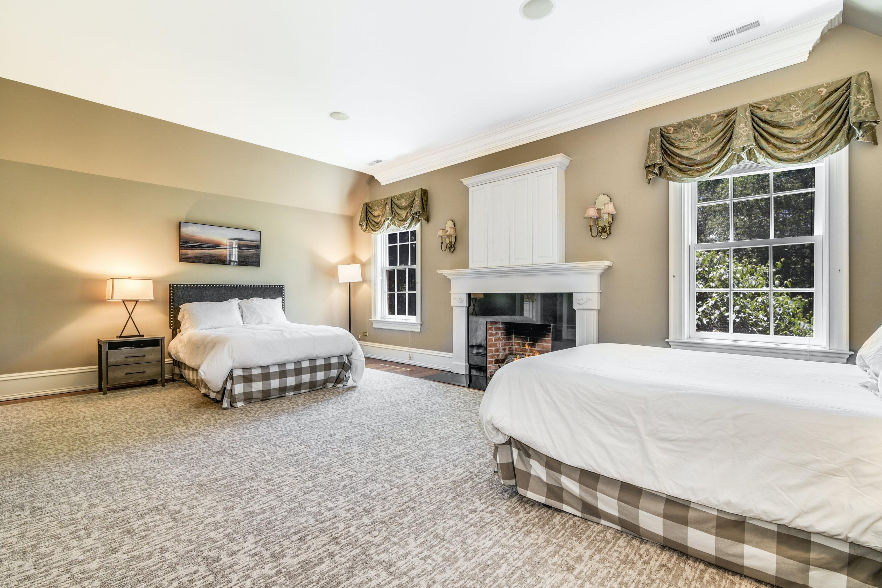 910 Smith Ridge Road New Canaan, CT 06840 - Photo 23 of 40 a bedroom with a bed and a fireplace