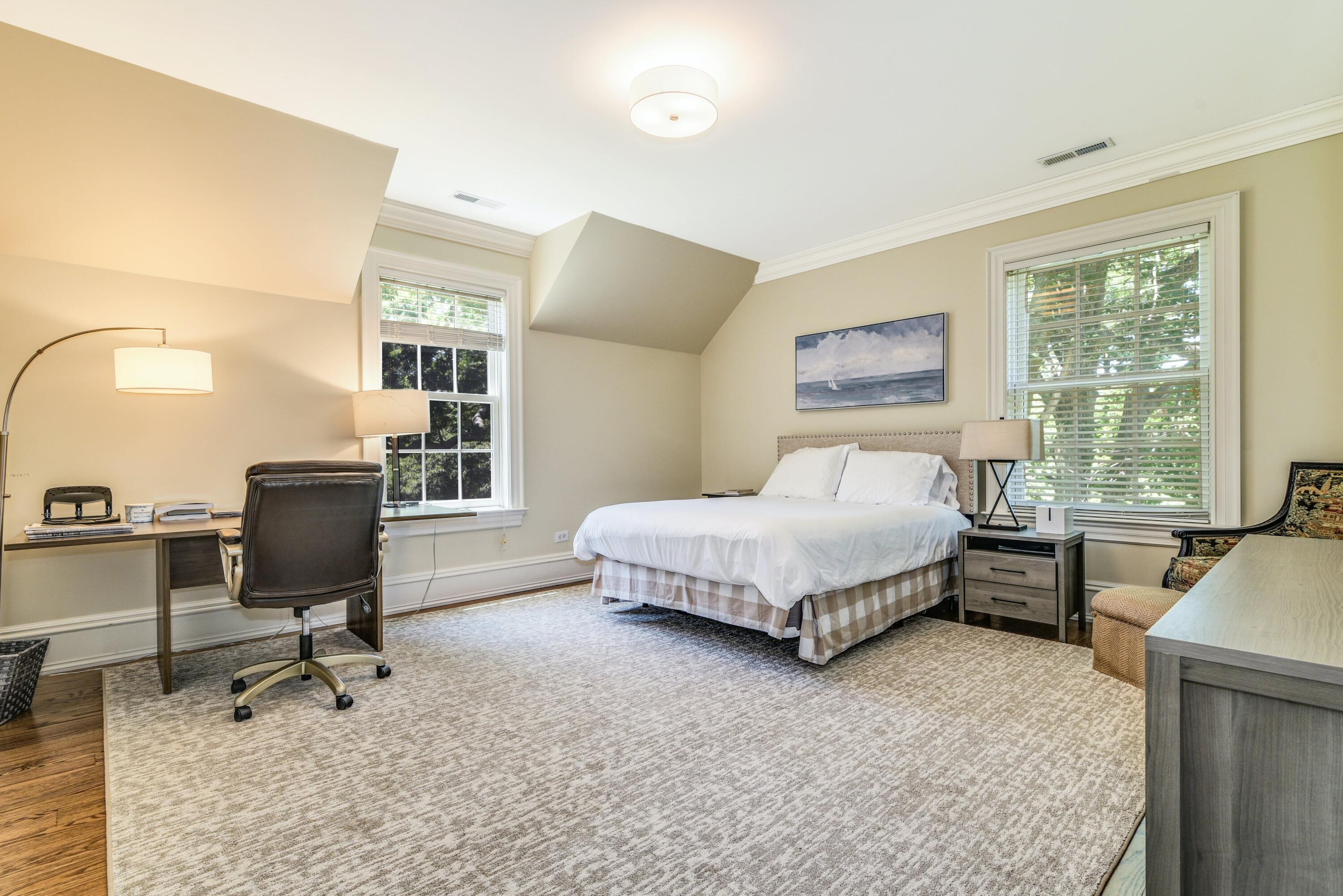 910 Smith Ridge Road New Canaan, CT 06840 - Photo 24 of 40 a bedroom with a bed a chair and painting on the wall