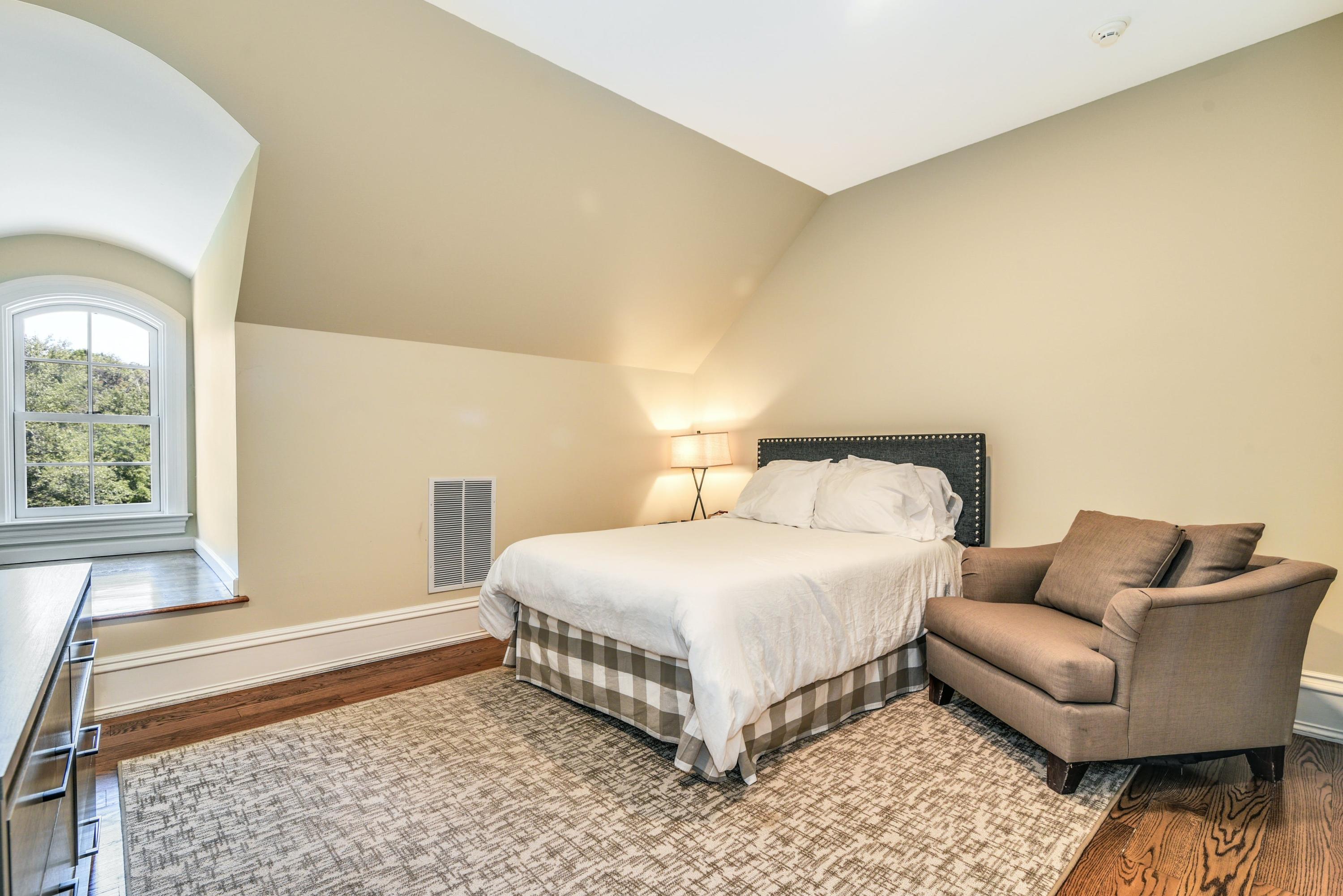 910 Smith Ridge Road New Canaan, CT 06840 - Photo 27 of 40 a bedroom with a bed and a couch