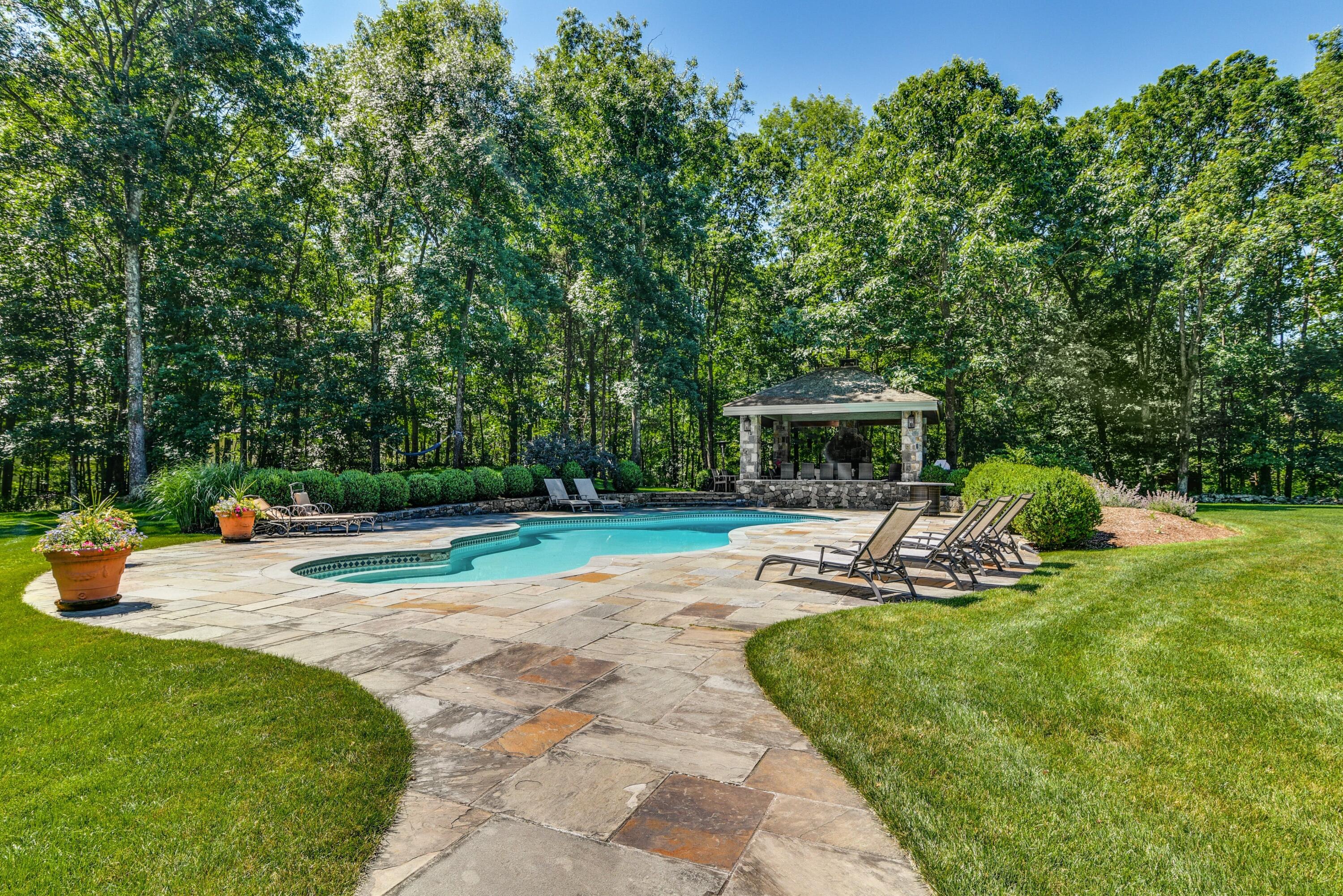910 Smith Ridge Road New Canaan, CT 06840 - Photo 30 of 40 a view of a backyard with sitting area