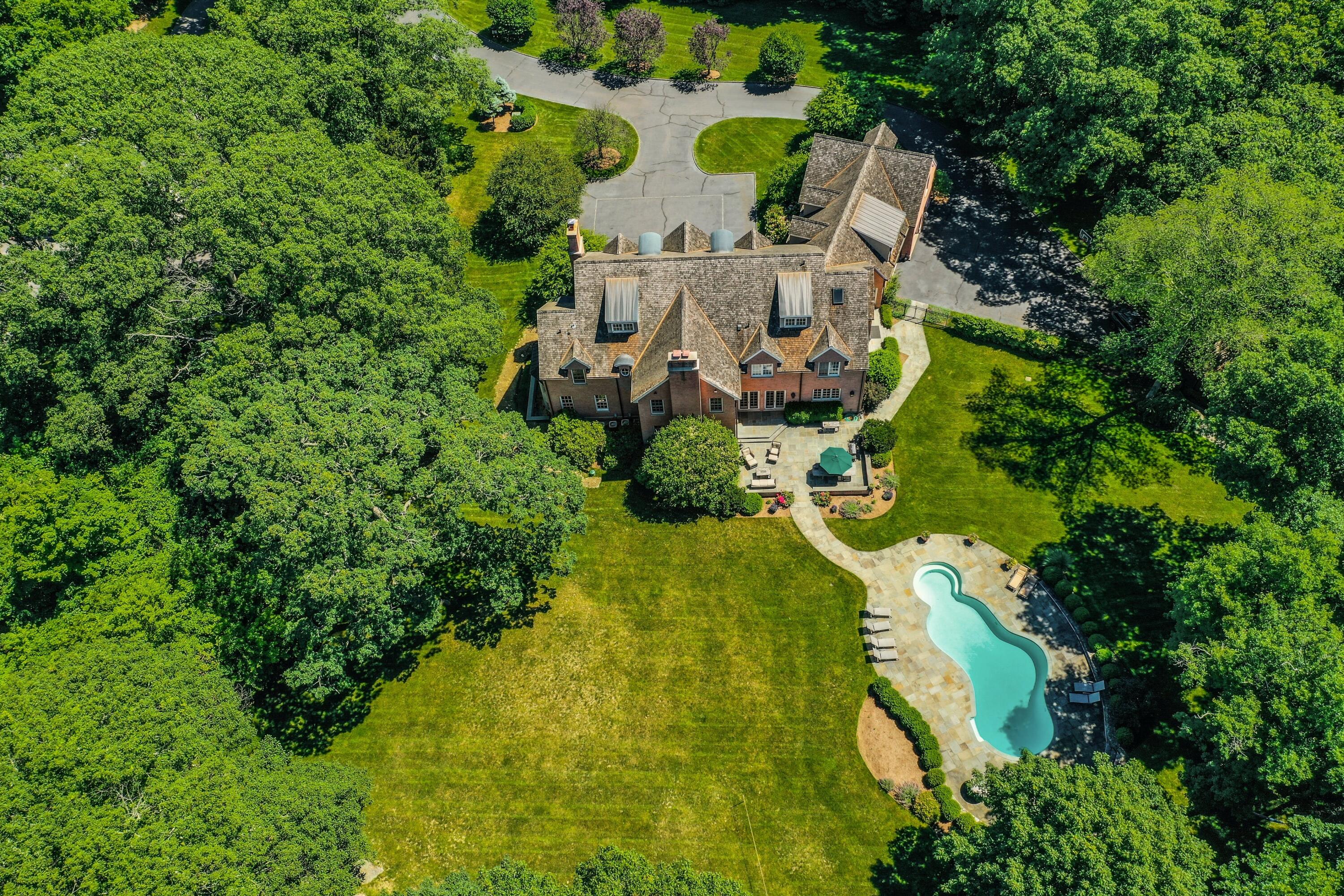 910 Smith Ridge Road New Canaan, CT 06840 - Photo 4 of 40 an aerial view of residential house with outdoor space and trees all around