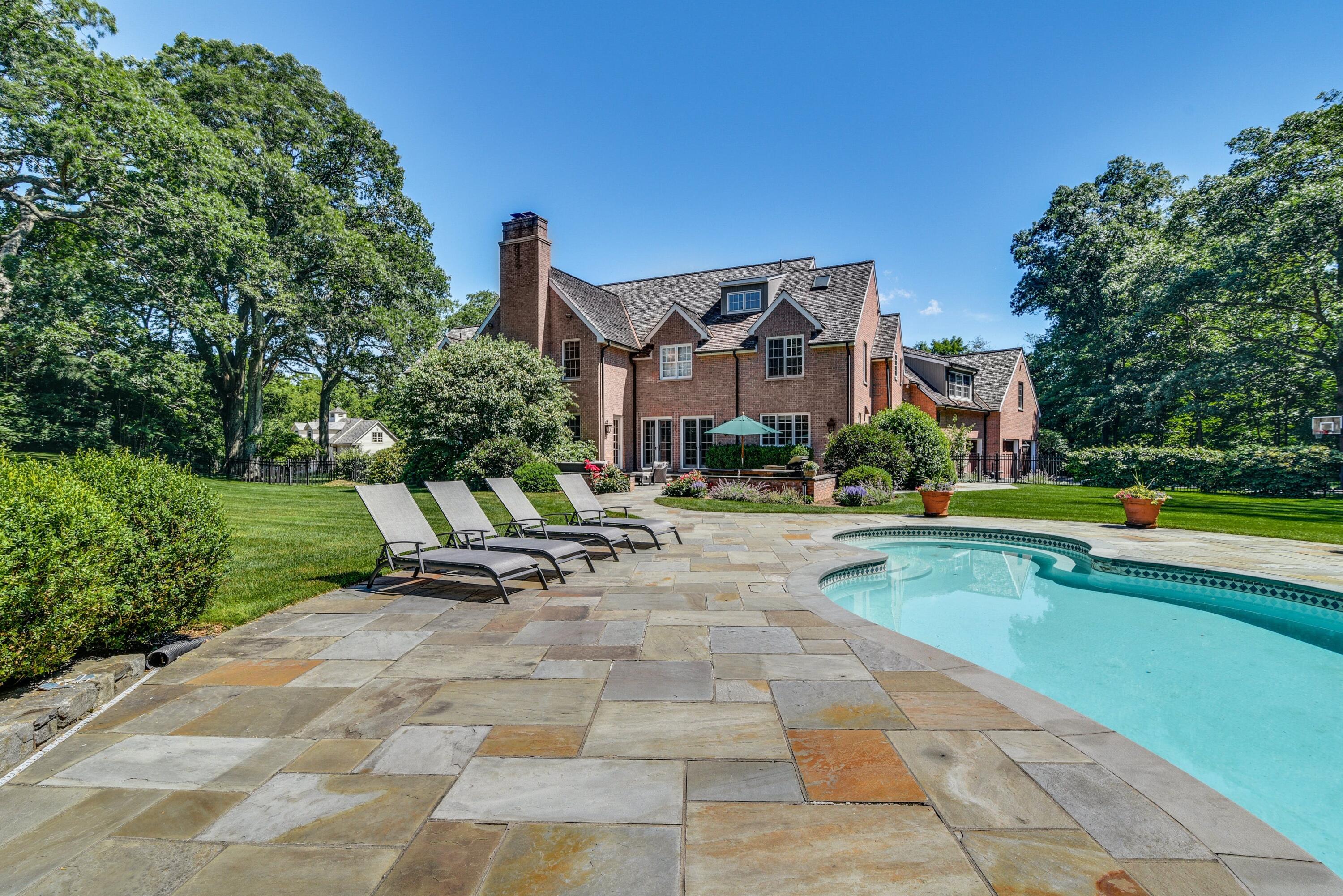 910 Smith Ridge Road New Canaan, CT 06840 - Photo 32 of 40 a view of pool with lawn chairs and large trees