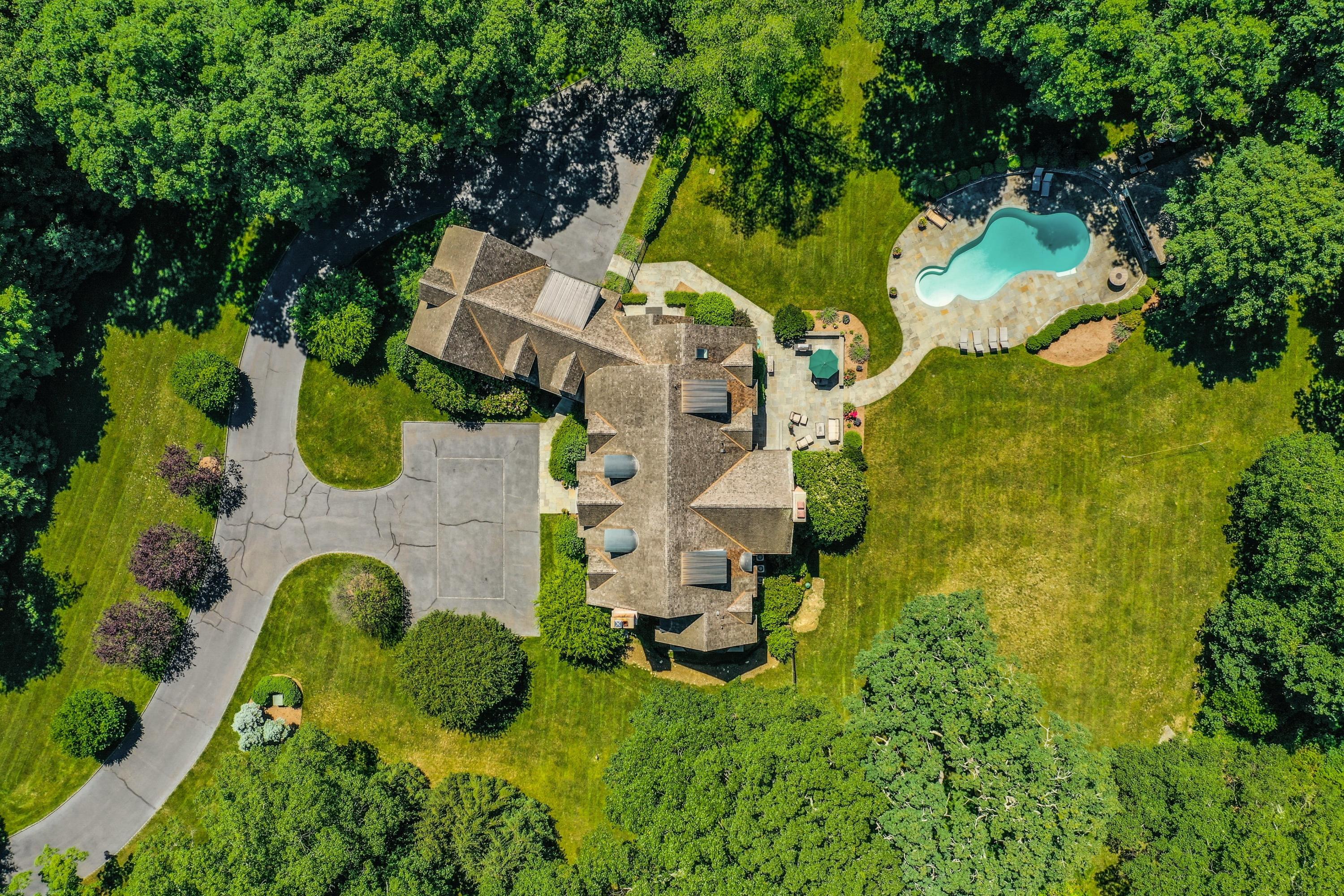 910 Smith Ridge Road New Canaan, CT 06840 - Photo 34 of 40 an aerial view of a house with swimming pool and large trees