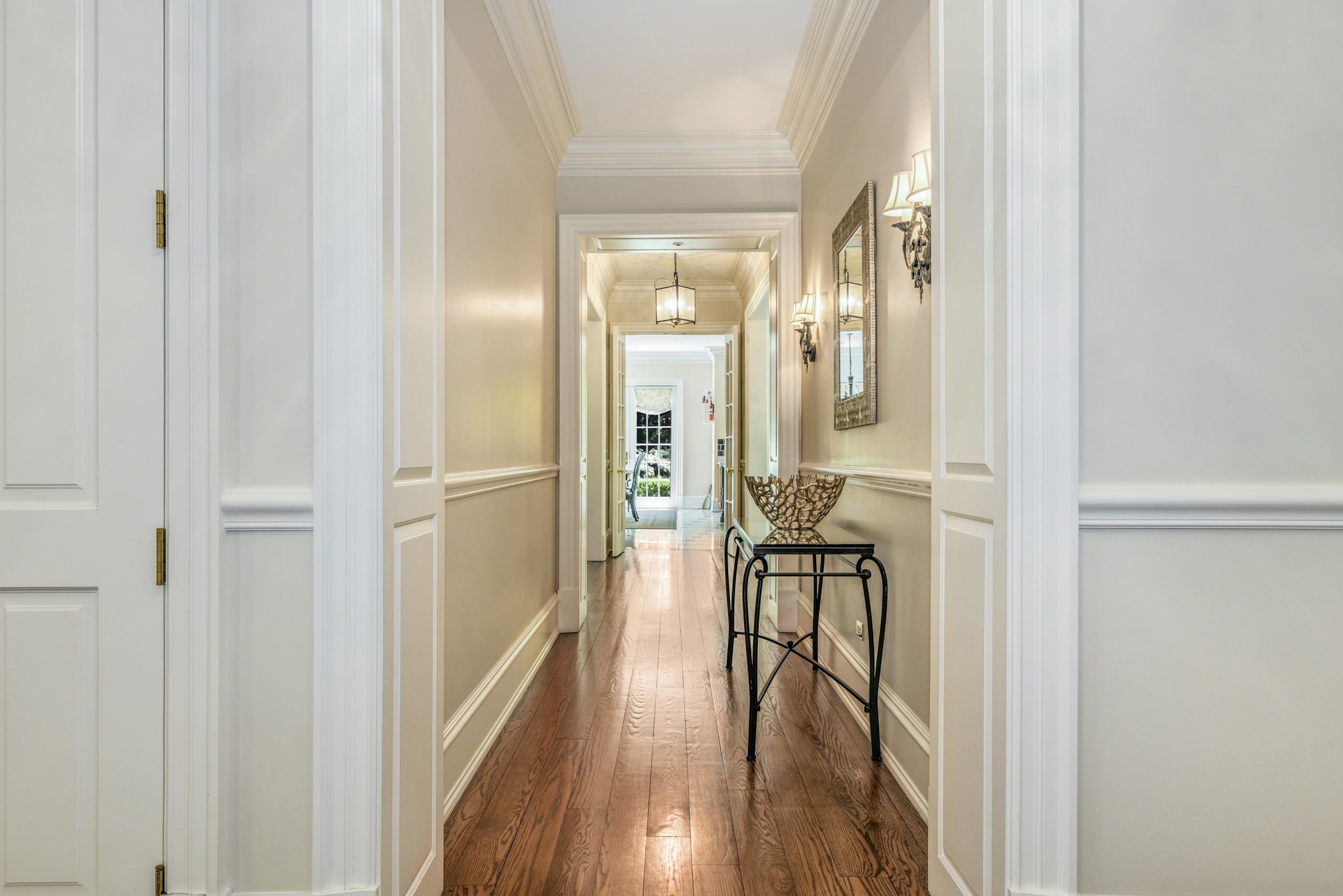 910 Smith Ridge Road New Canaan, CT 06840 - Photo 10 of 40 a view of a hallway with wooden floor furniture and windows