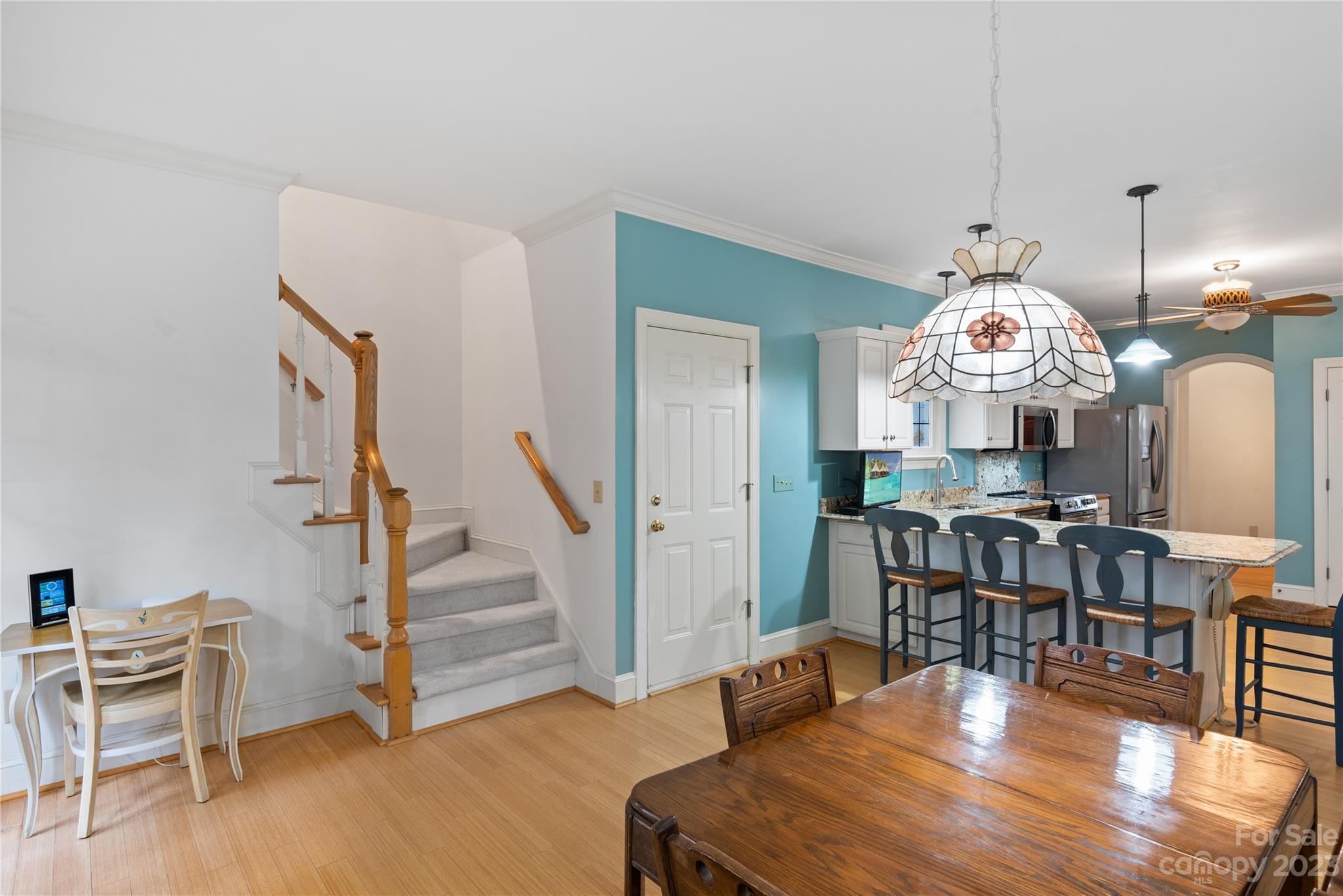 7604 Bosham Lane Charlotte, NC 28270 - Photo 16 of 39 a view of a dining room with furniture a chandelier and wooden floor