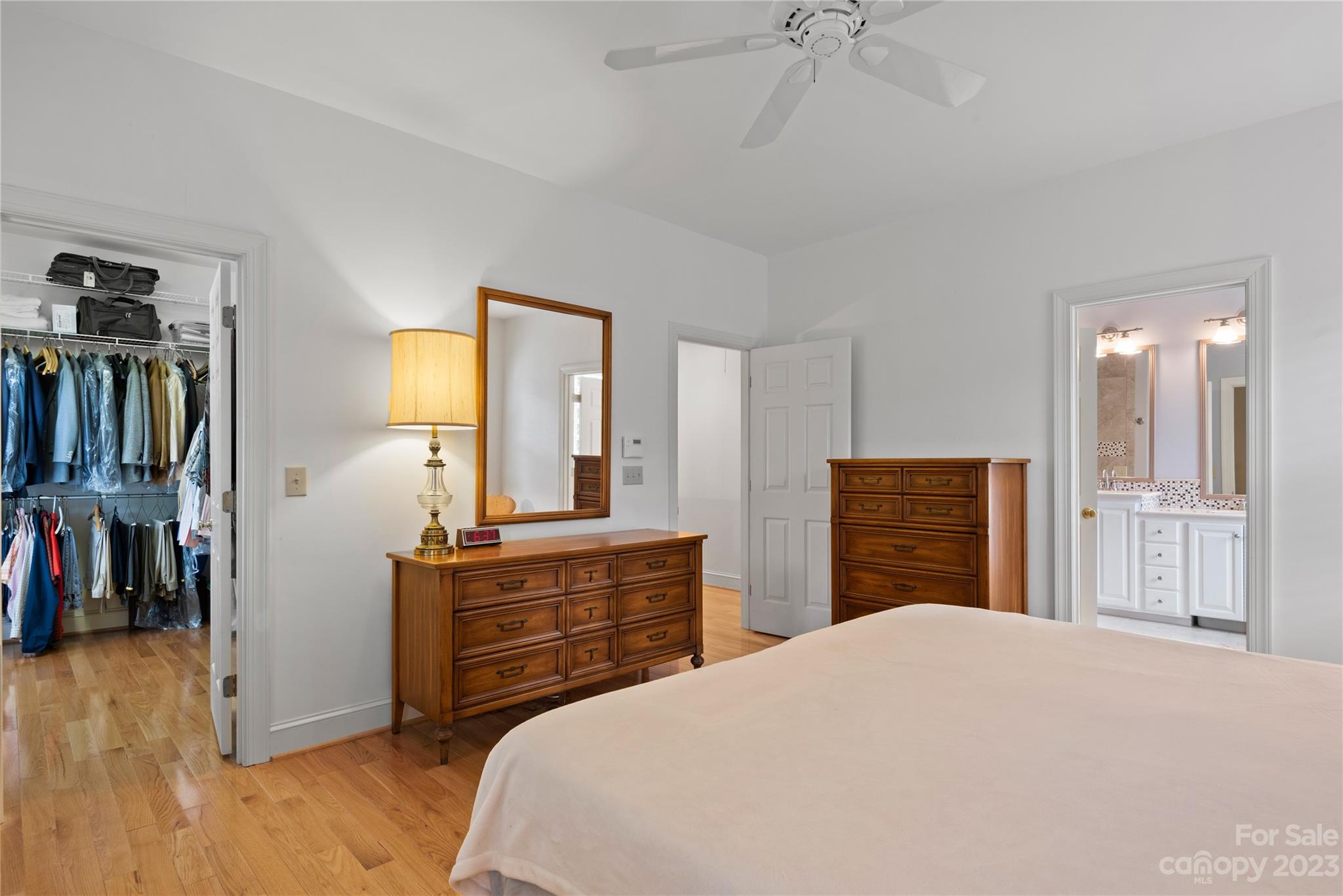 7604 Bosham Lane Charlotte, NC 28270 - Photo 21 of 39 a bedroom with a bed and a chandelier